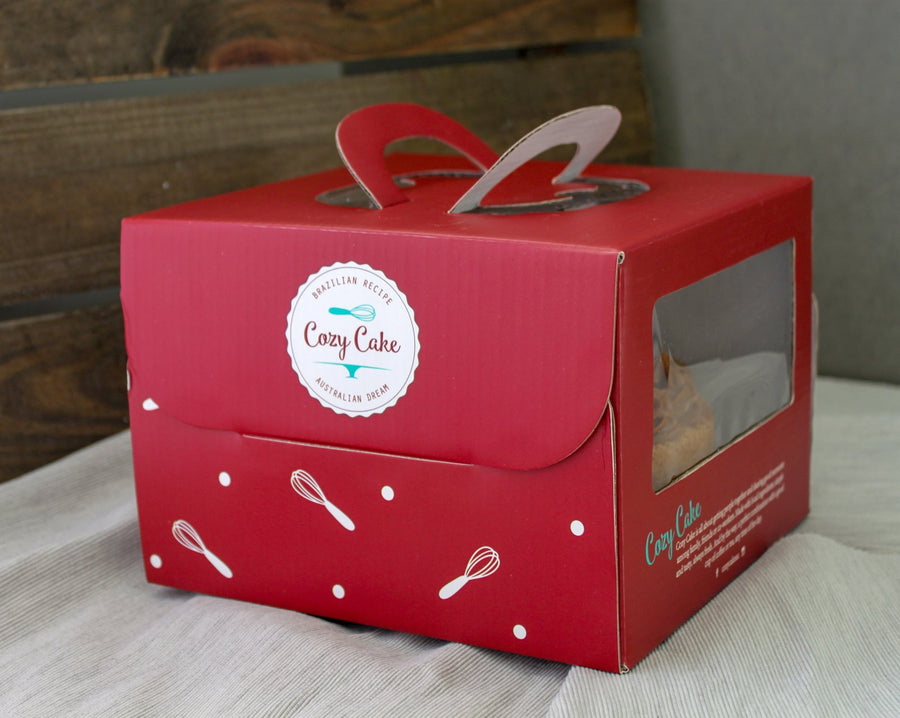 Cozy Cake in its red box, ready for pickup or delivery
